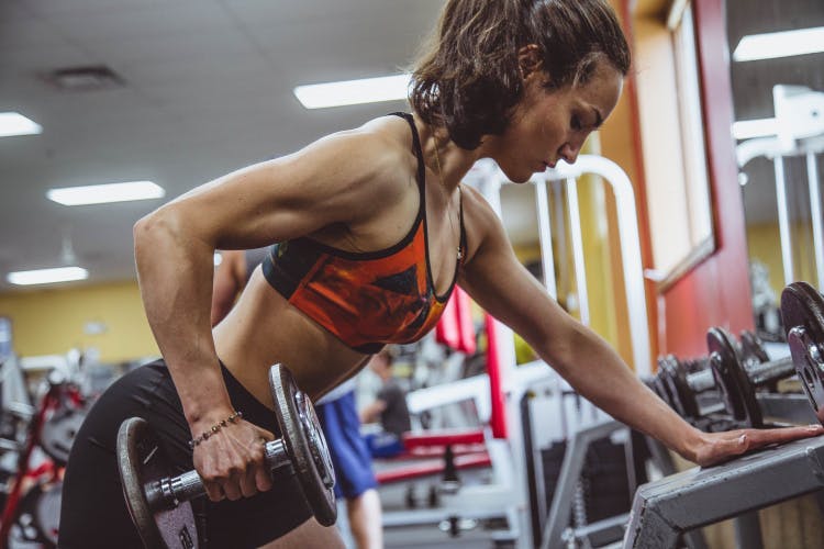 woman weight training at gym