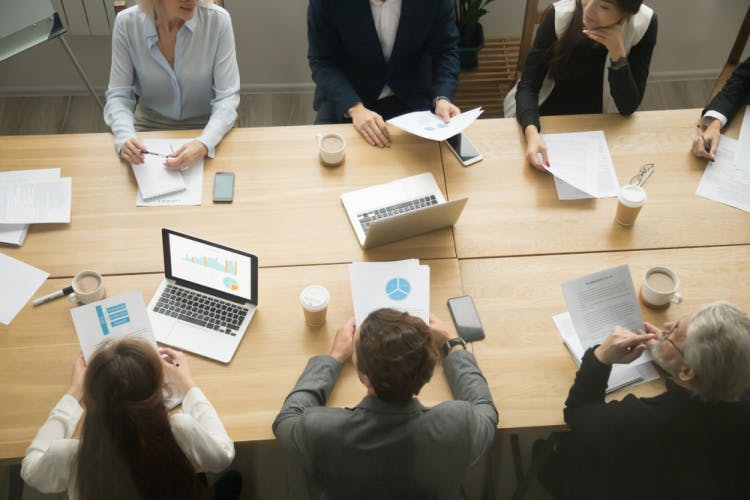 Business,Young,And,Senior,People,Group,Working,Together,Sitting,At Table