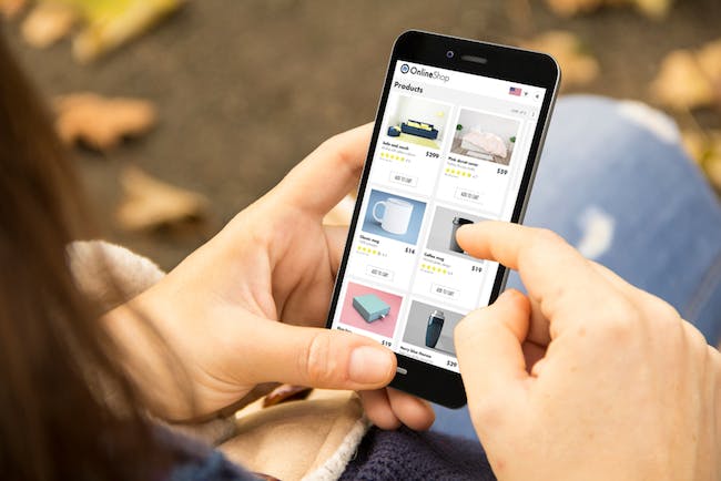 person browsing online shop on mobile phone. credit: shutterstock